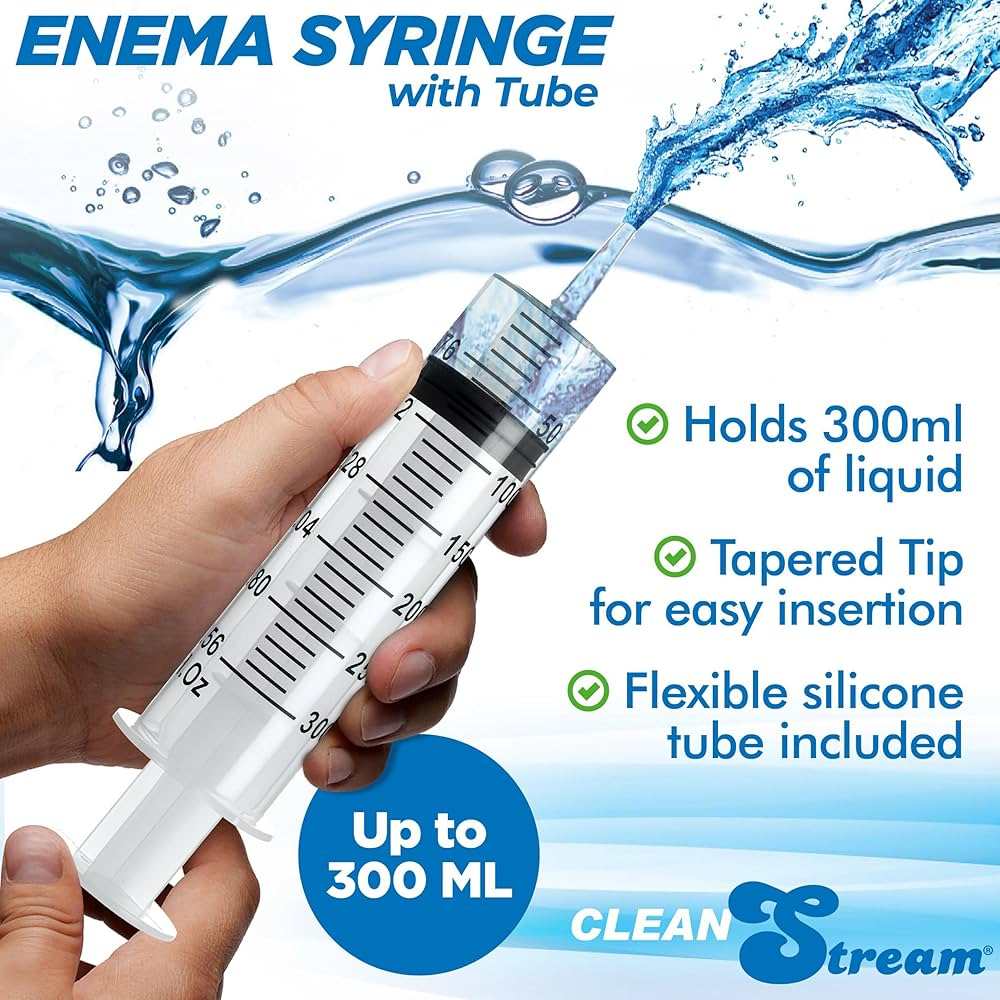 Hand holding CleanStream 300ml enema syringe with clear measurement markings, tapered tip, and flexible silicone tube, designed for easy insertion and liquid control.