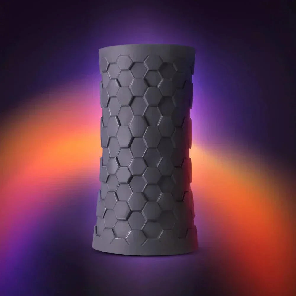 Hekx Silicone Stroker with textured hexagonal design on a colorful gradient background.