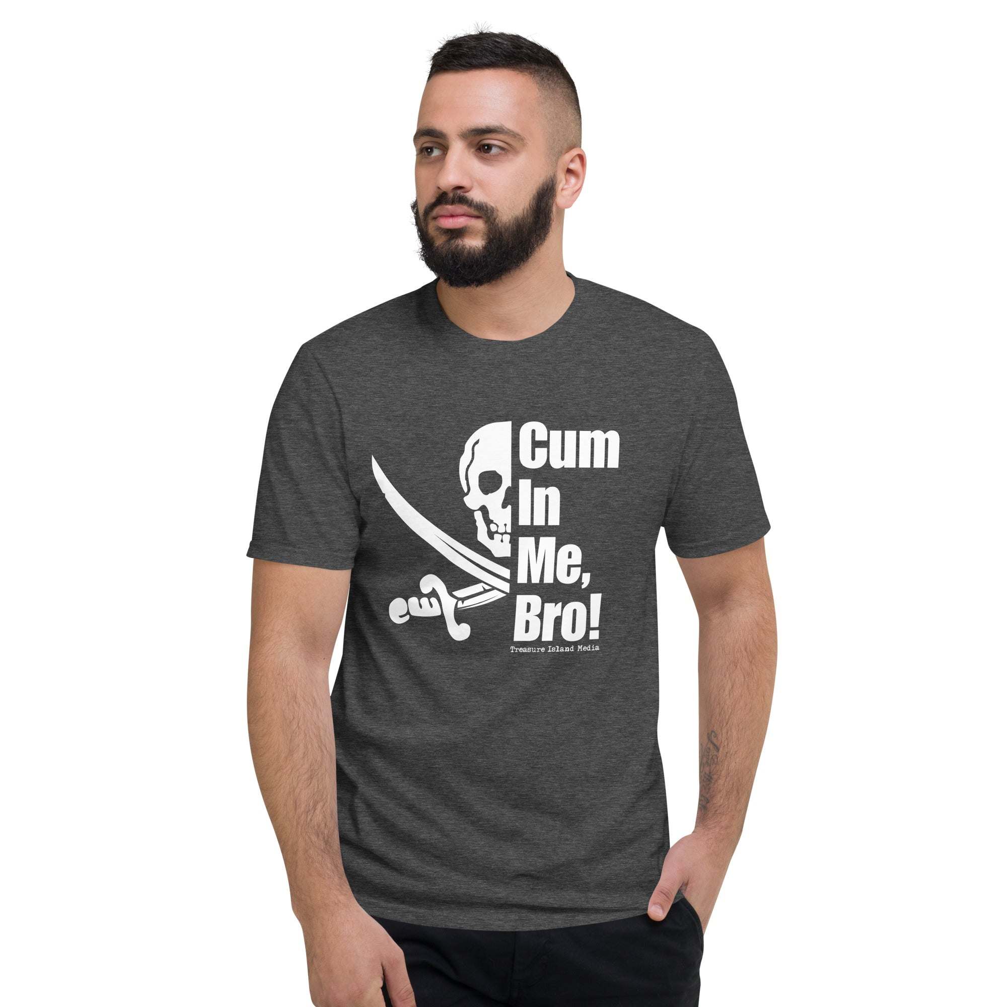 Man wearing dark grey Cum in me, Bro! T-Shirt with skull and crossed swords graphic and bold white text.