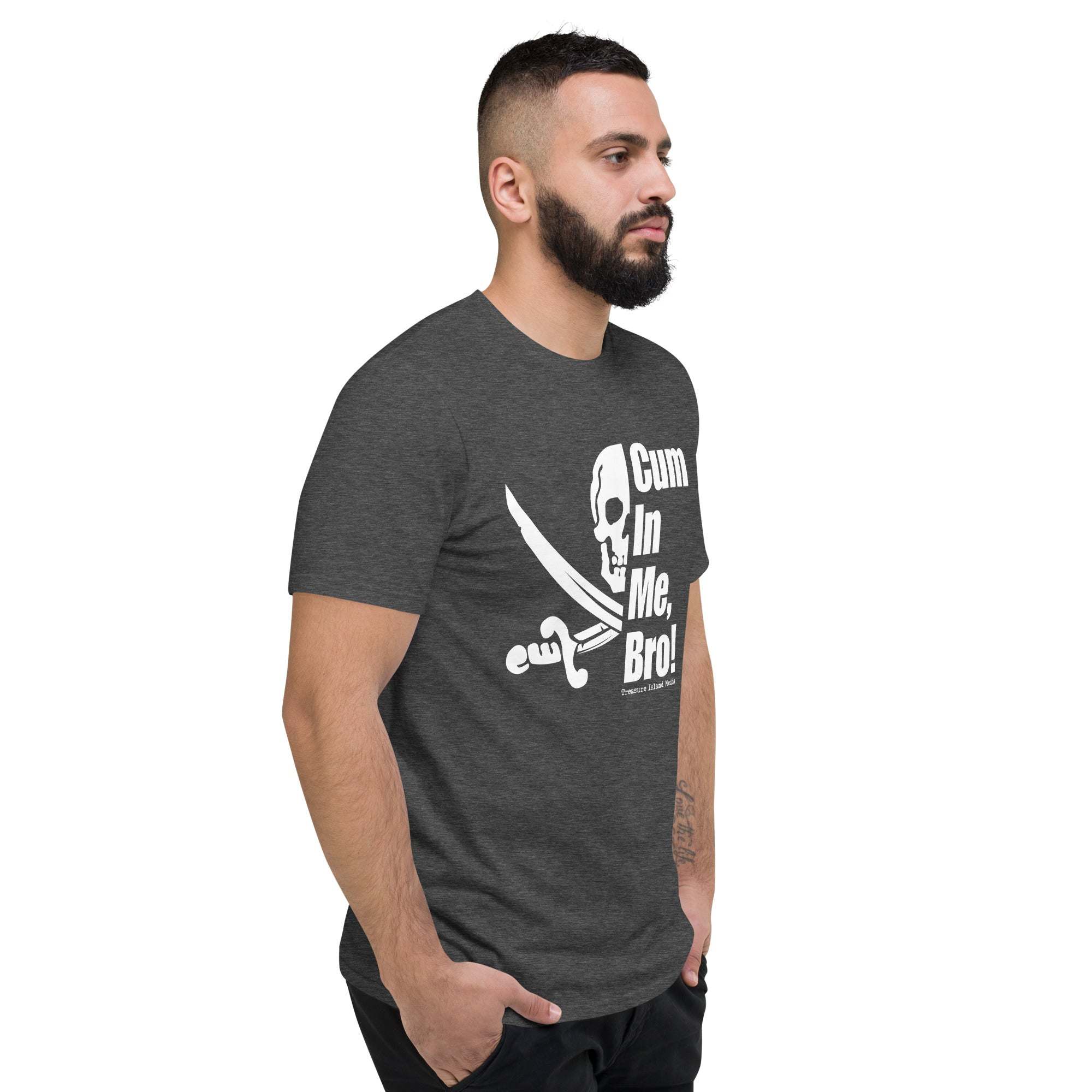 Man wearing dark grey Cum in me, Bro! T-Shirt with white skull and sword graphic on front, standing with hands in pockets