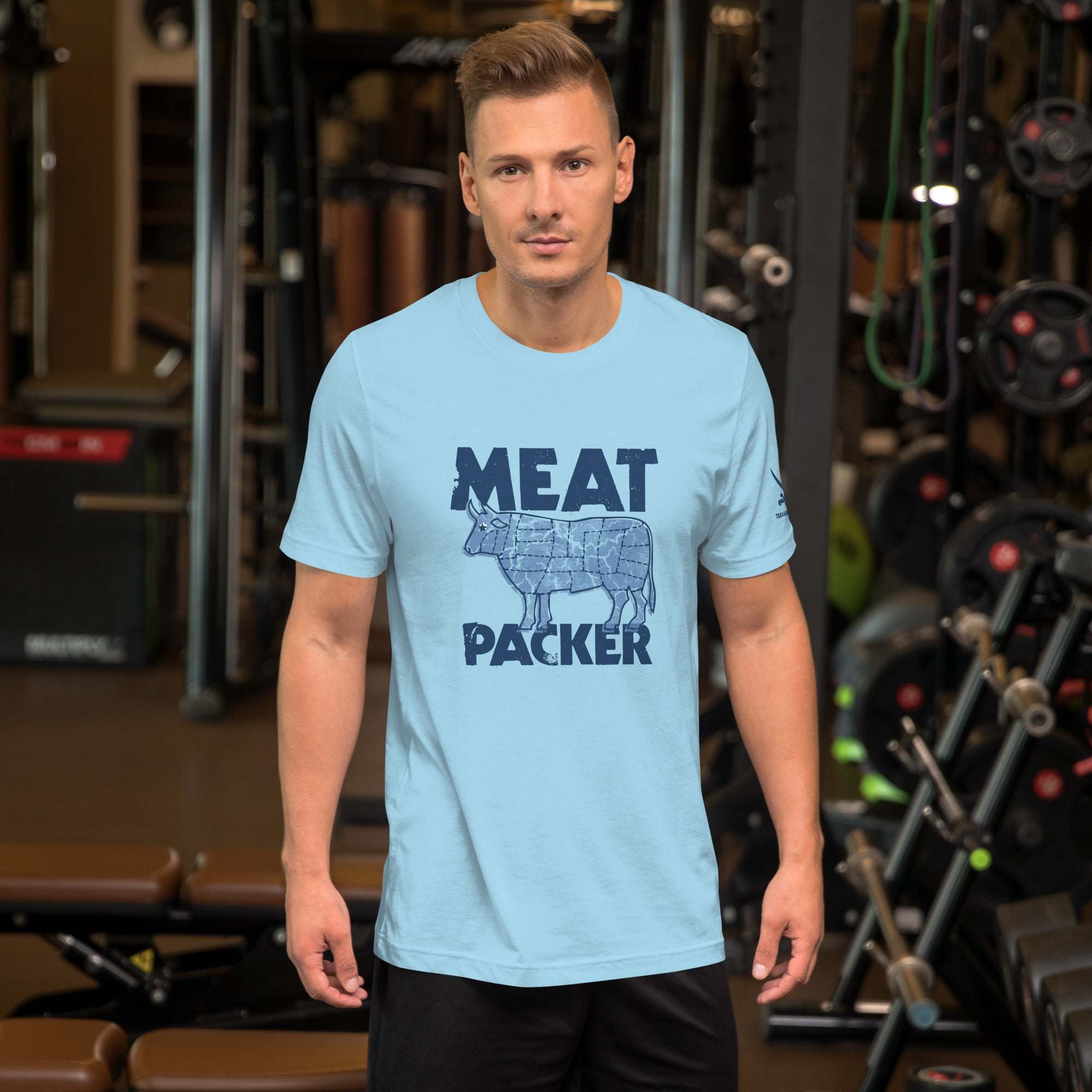 Man wearing a light blue Meat Packer T-Shirt in a gym setting.