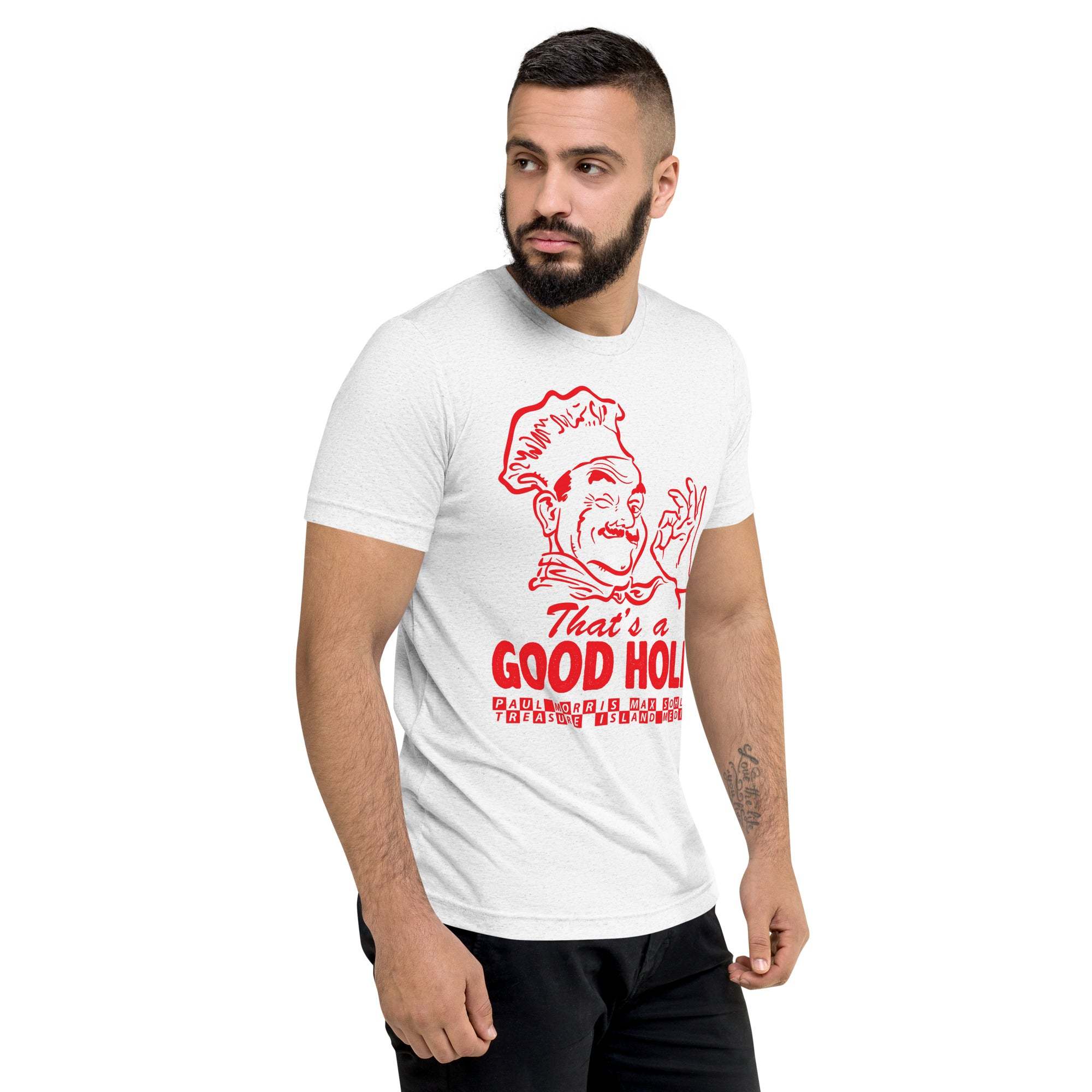 Man wearing white "That's a Good Hole" t-shirt featuring red graphic of a chef and text, paired with black pants.