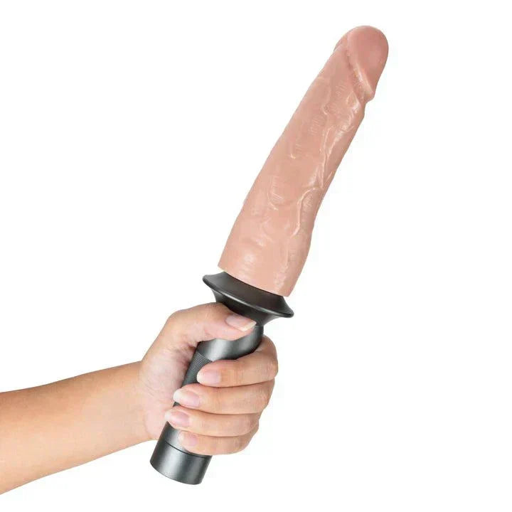 Blush Lock On Karbonite realistic 7.75 inch dildo with aluminum handle and suction cup adapter held in hand