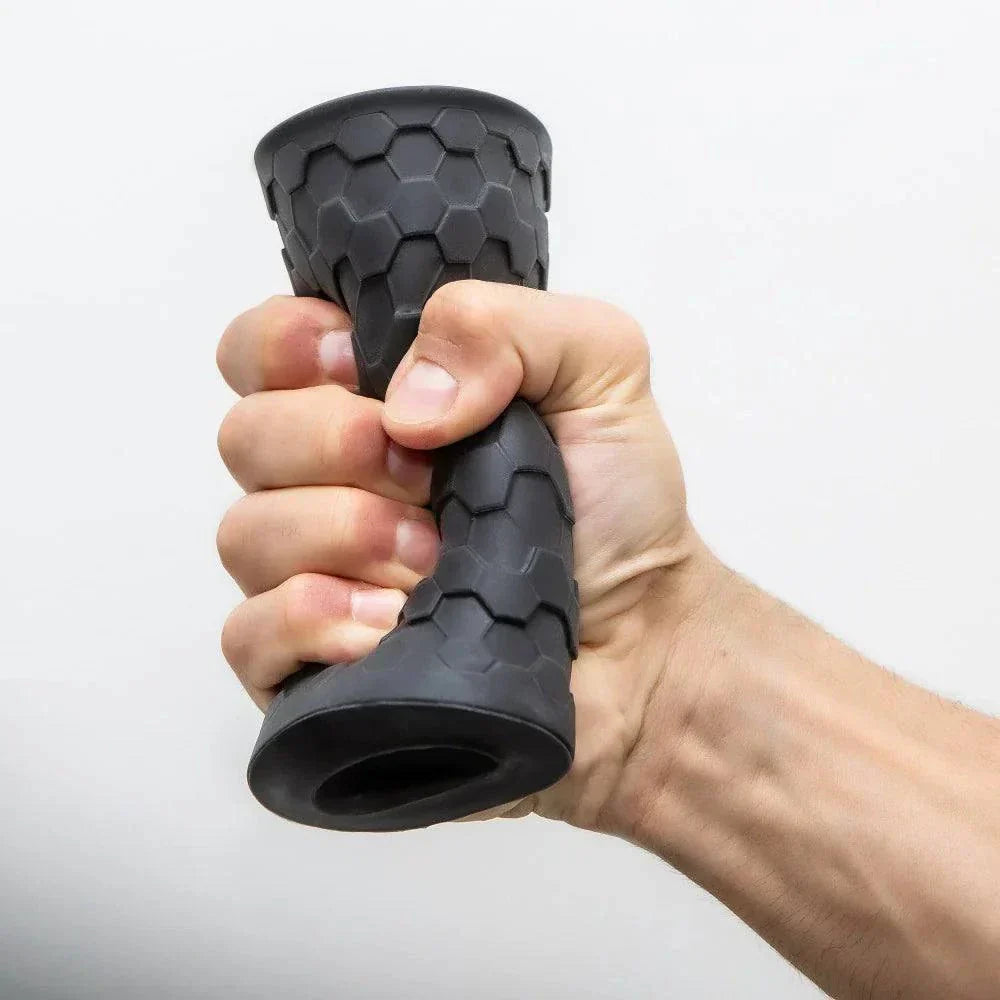 Hekx Silicone Stroker held in hand, showcasing textured design and ergonomic grip.