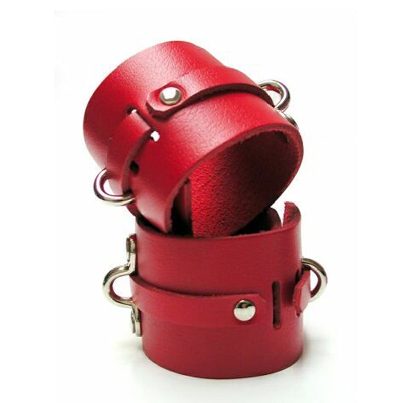 Red leather wrist cuffs with adjustable buckle and metal D-rings for bondage by KinkLab Bondage Basics