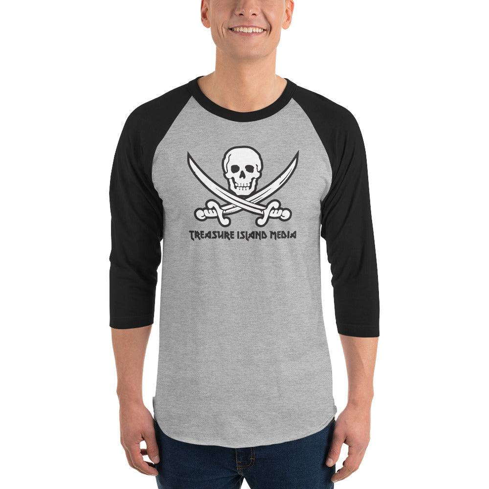 Man wearing Treasure Island Media logo baseball t-shirt with black sleeves and grey body featuring skull and crossed swords design.