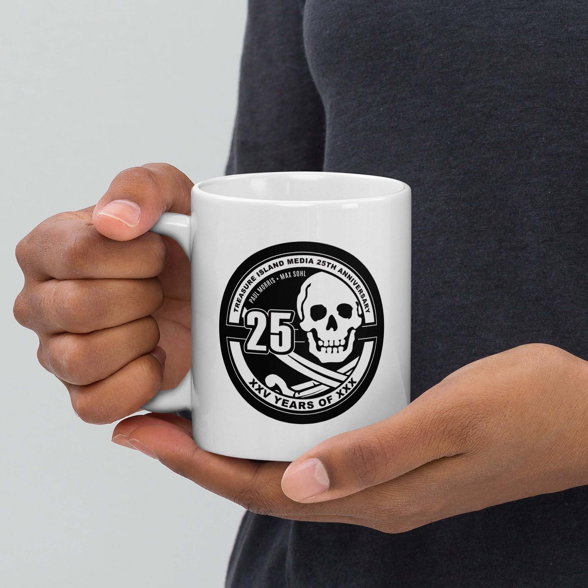 TIM 25th Anniversary Mug featuring iconic logo, high-quality ceramic, microwave and dishwasher safe.
