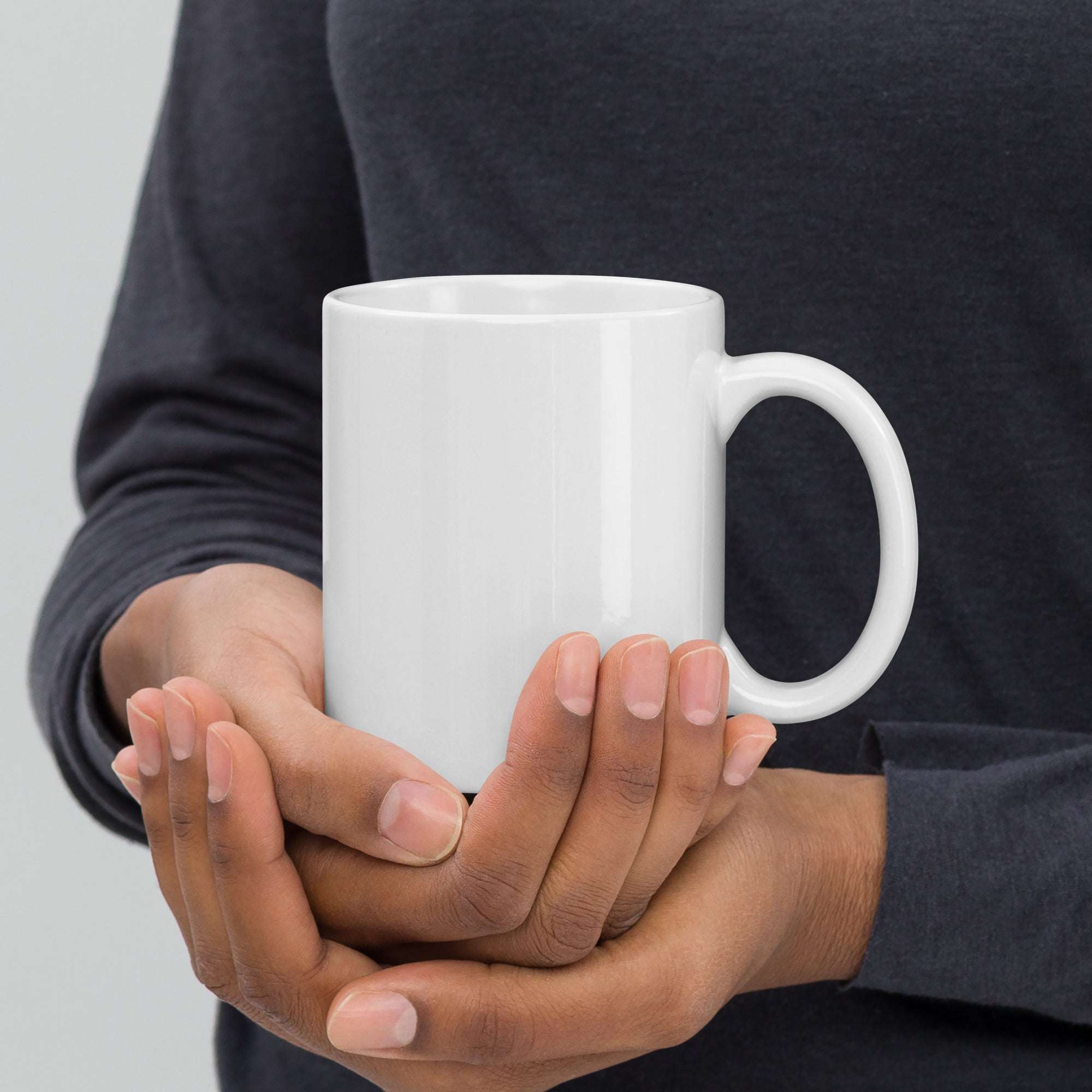 TIM 25th Anniversary Mug held in hands, celebrating a milestone with sleek design and iconic logo.