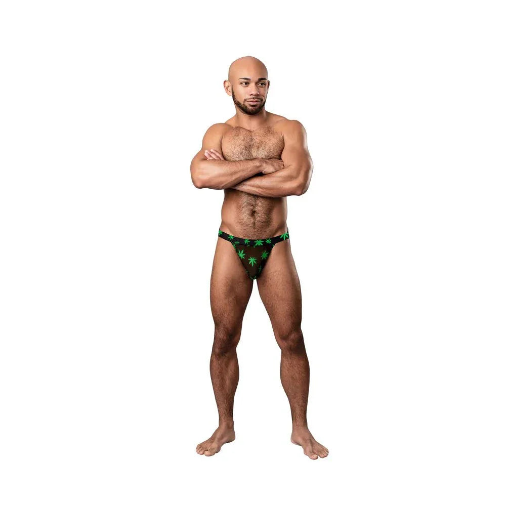 Male model wearing Male Power Hazy Dayz black sheer mesh jockstrap with green pot leaf print and matching waistband S/M size