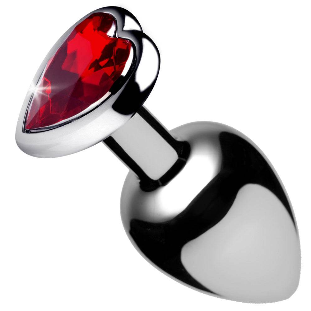 Medium-sized metallic anal plug with a red heart-shaped gem tip, smooth aluminum finish.