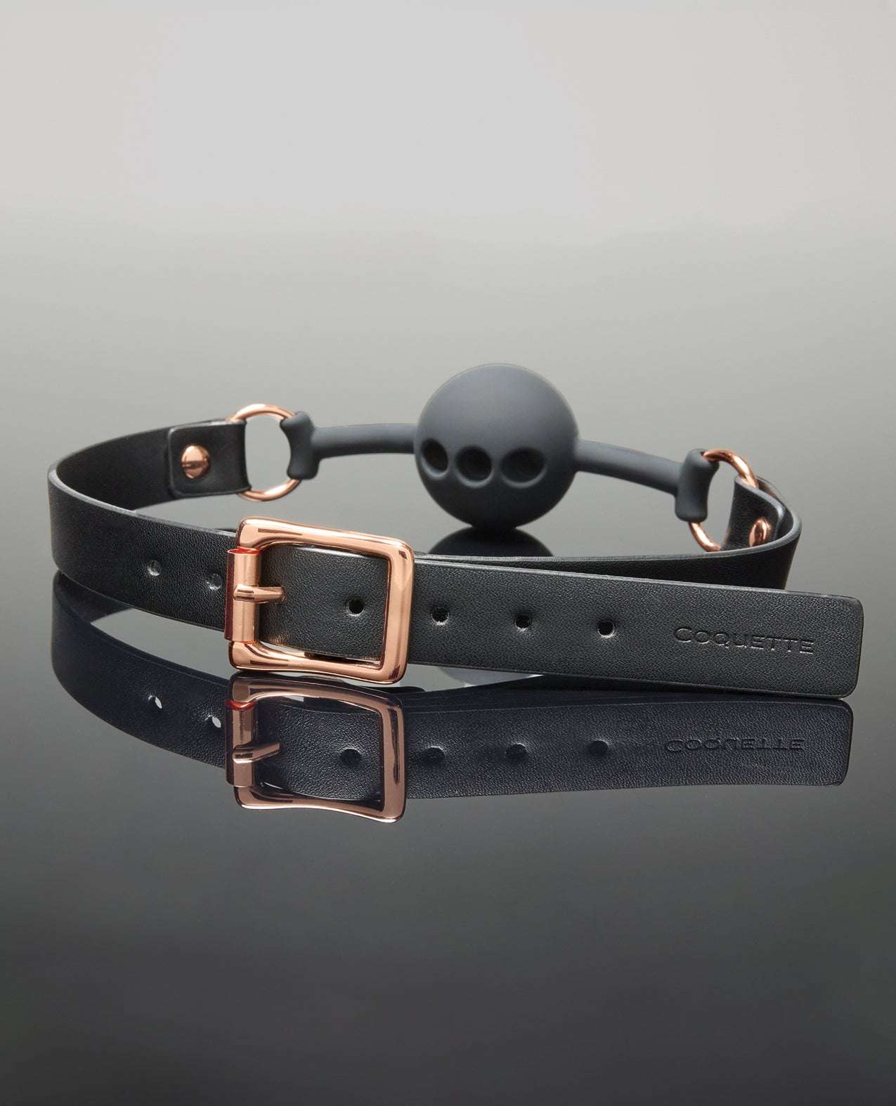 Pleasure Collection Adjustable Ball Gag in black silicone with rose gold buckle and breathing holes for comfortable restraint play