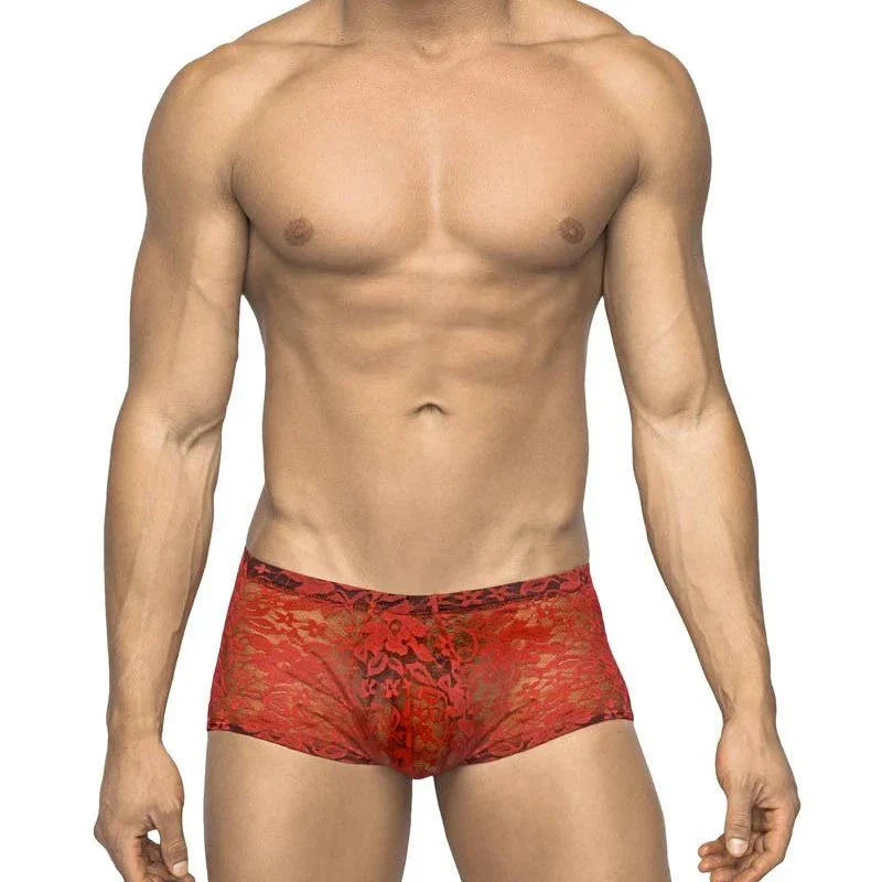 Male model wearing red Male Power Stretch Lace Mini Short with low-rise waist and soft lace fabric, size XL.