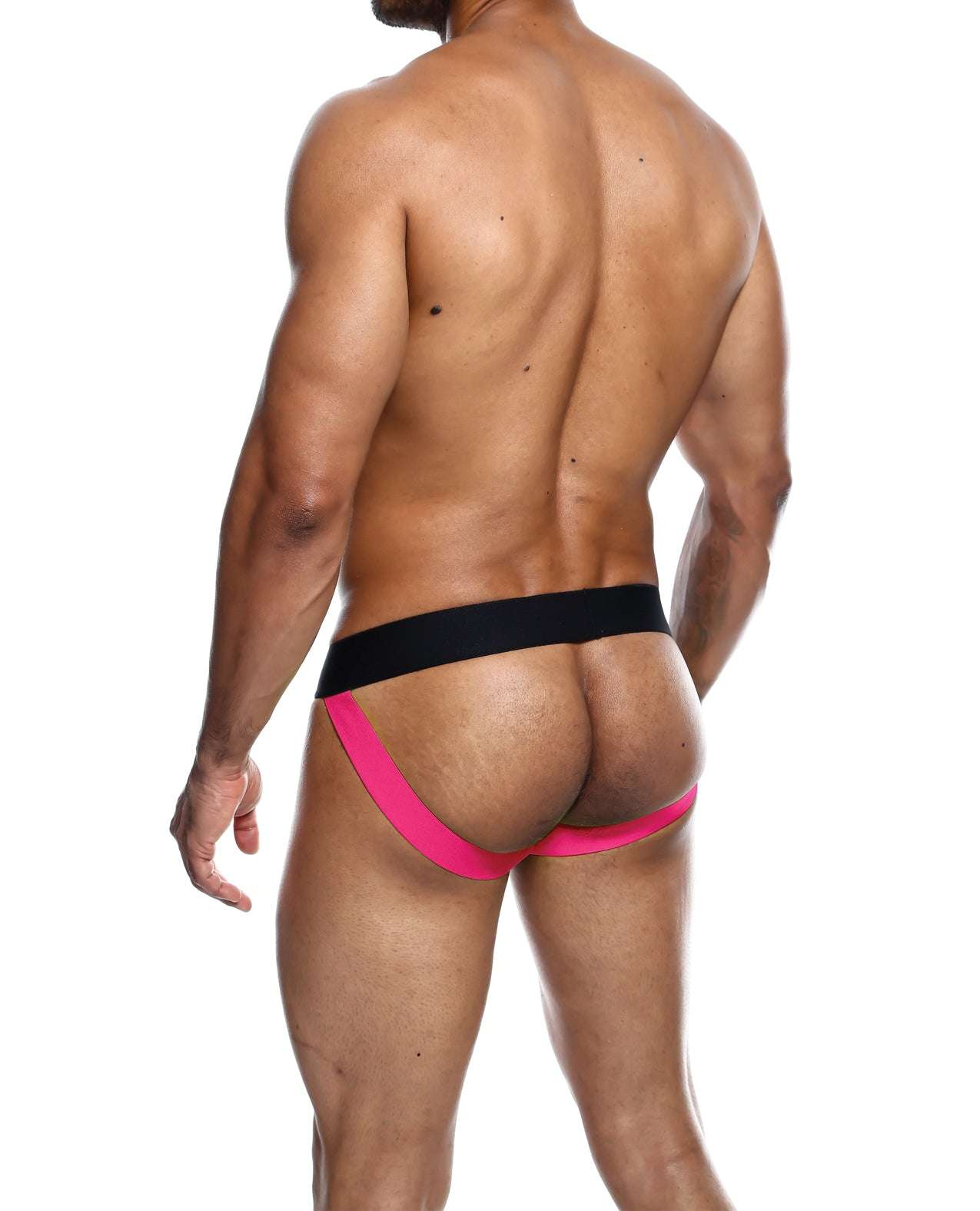 Male wearing Male Basics Neon Jockstrap coral collection with black waistband and neon coral straps, back view