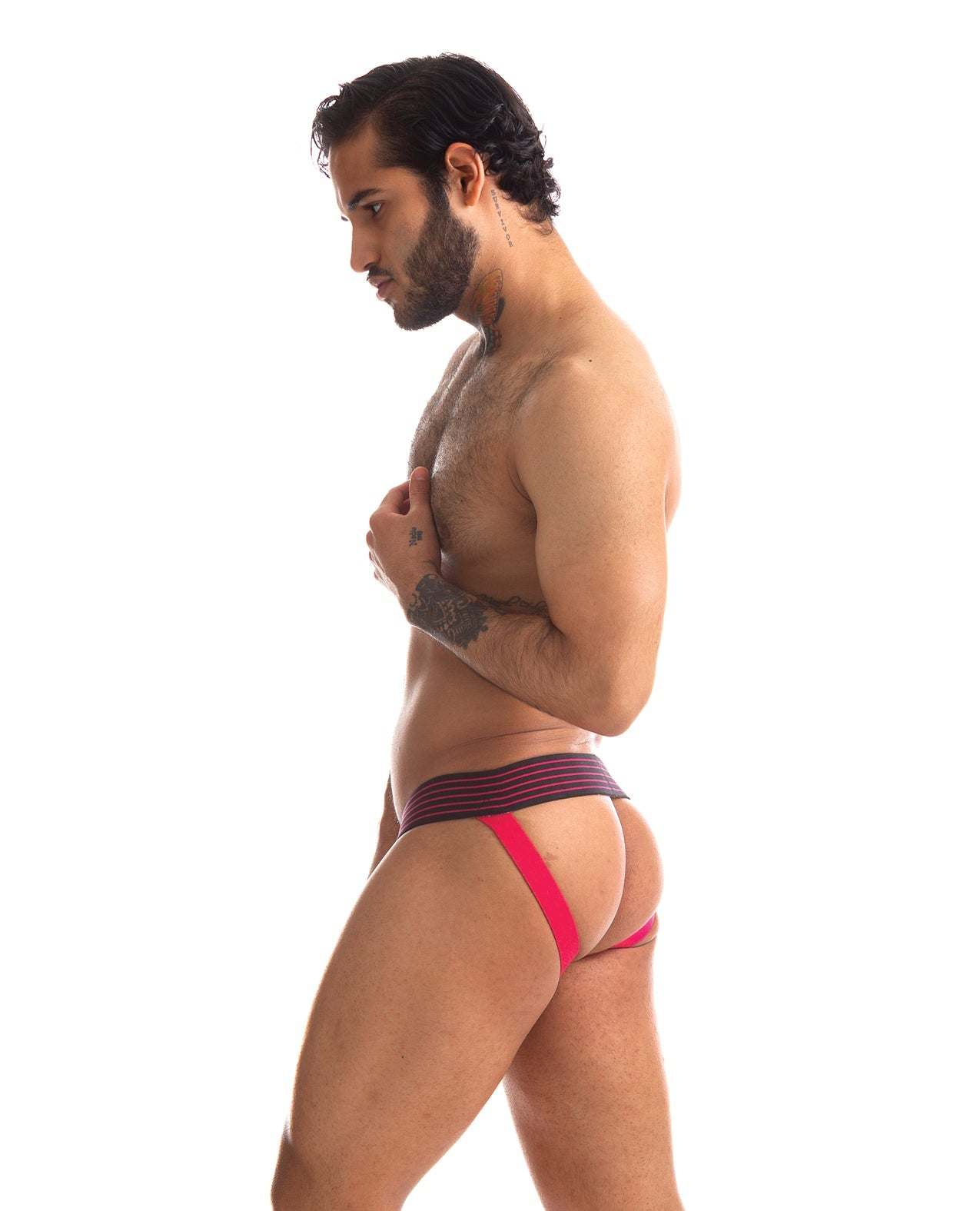 Male model wearing 665 Rally Jockstrap with red straps and black waistband against white background