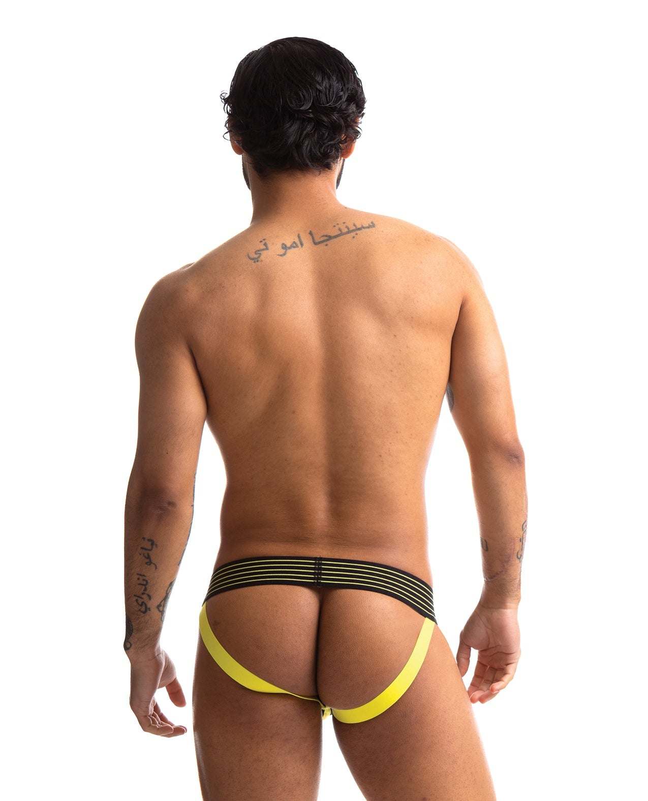 Man wearing 665 Rally Jockstrap with black and yellow straps, viewed from the back.