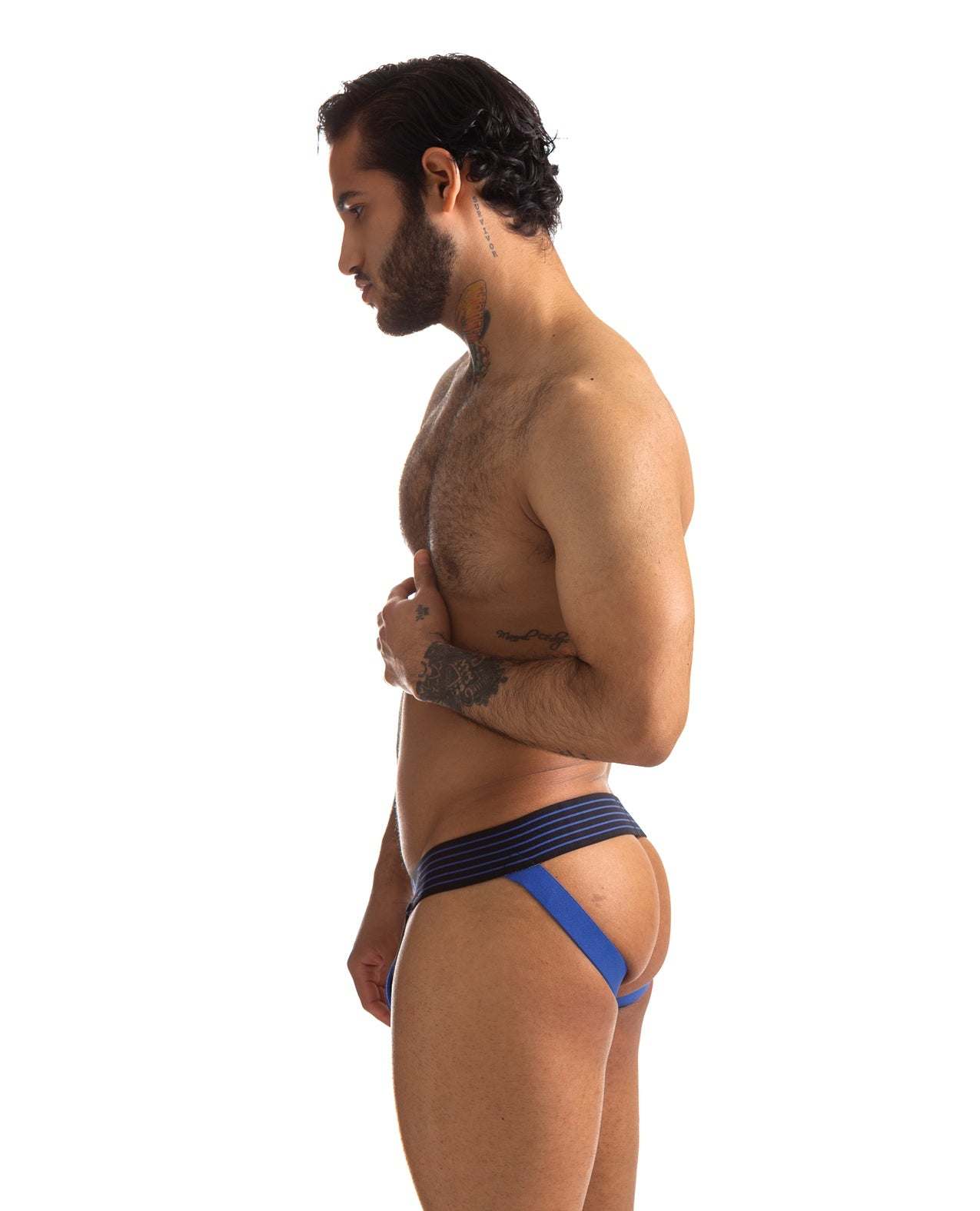 Side view of a man wearing the 665 Rally Jockstrap in blue with black waistband showing its fit and support
