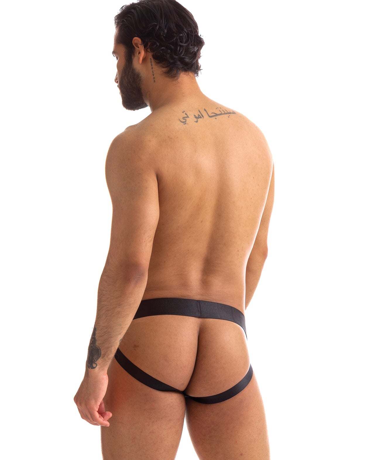 Rear view of a man wearing a black 665 Stealth Jockstrap with supportive elastic straps designed for active comfort and style.