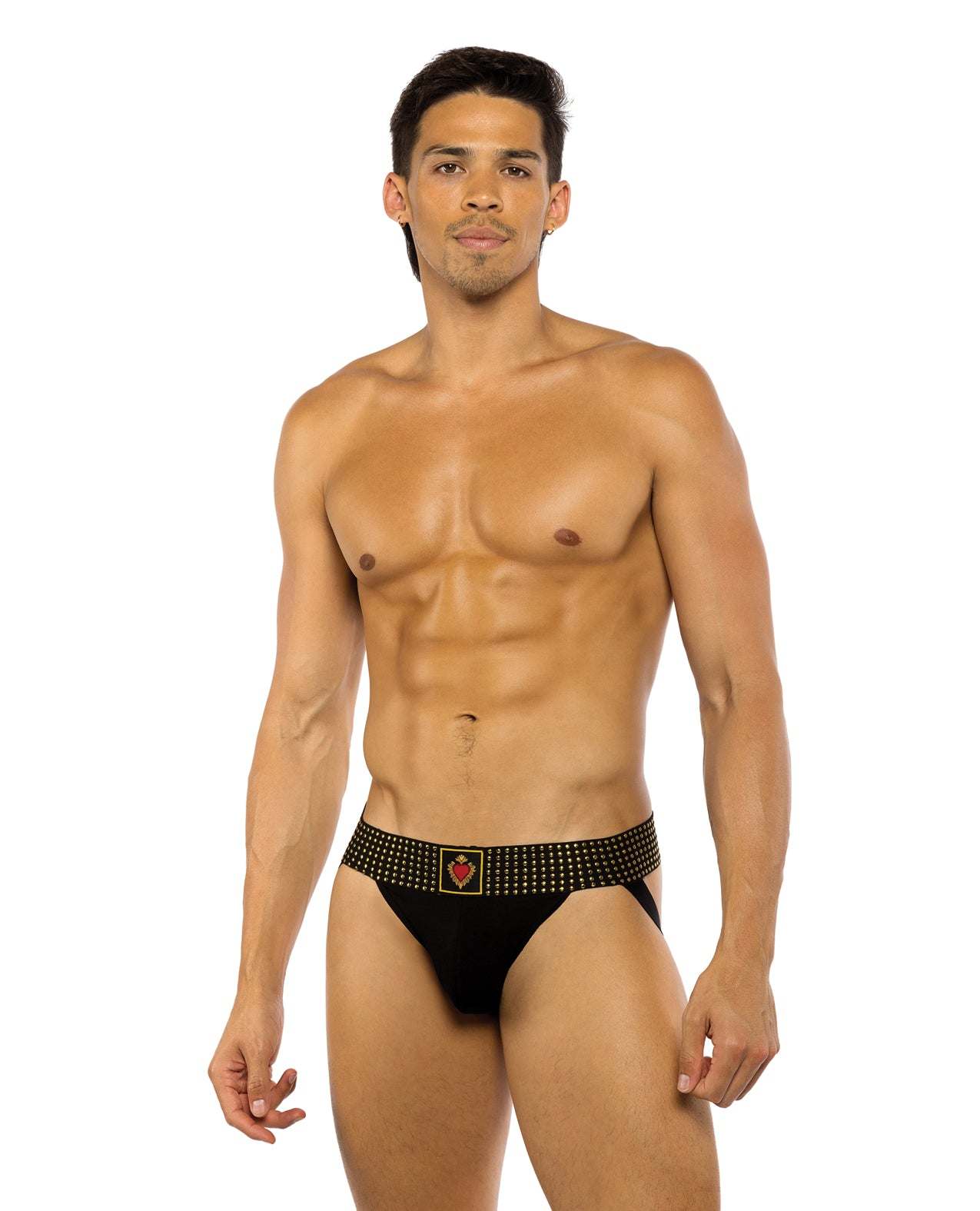 Male model wearing black Sacred Heart Jockstrap with contoured pouch and studded elastic waistband, size XL