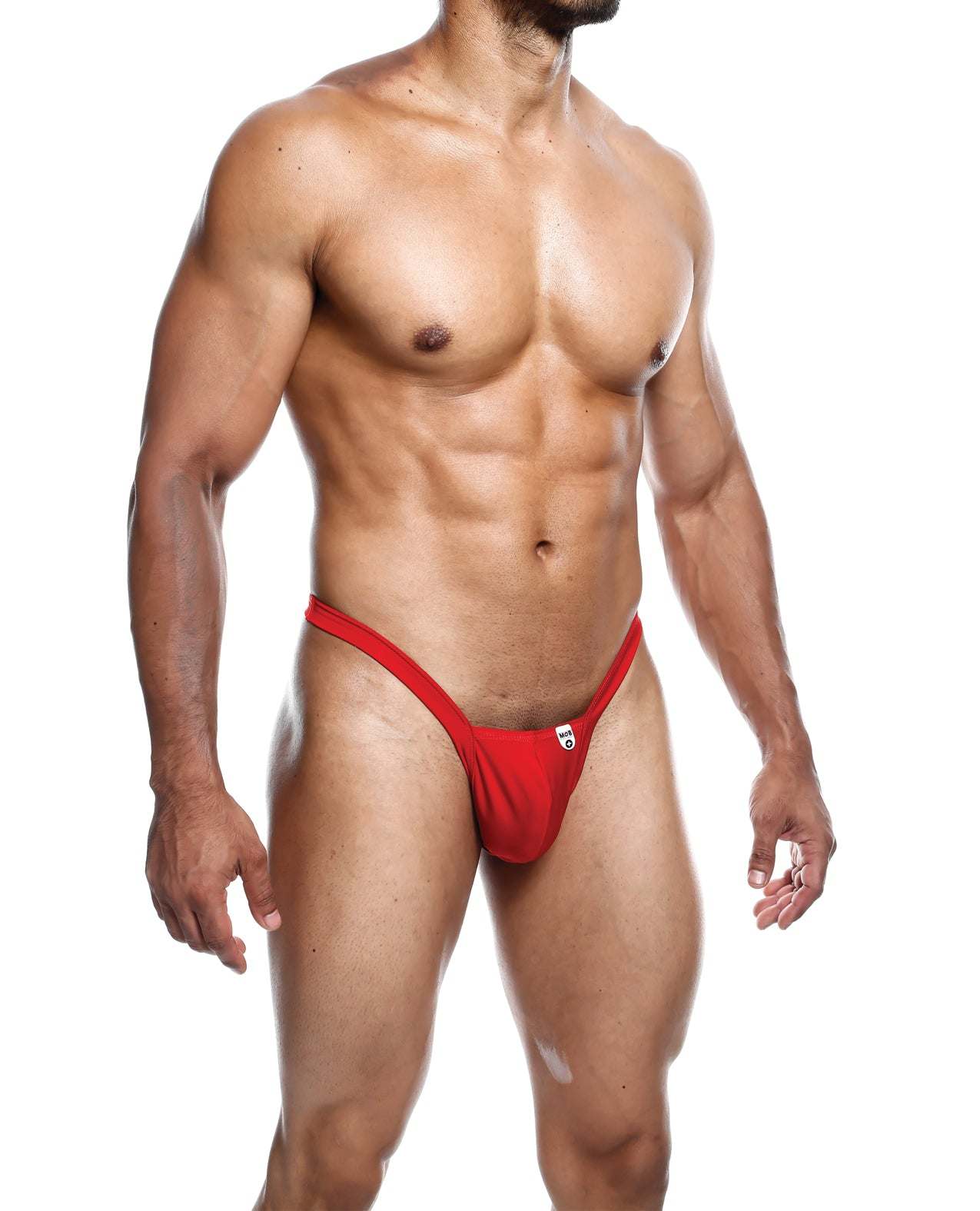 male model wearing red Male Basics Y Buns Thong showcasing sheer, minimal coverage men's underwear