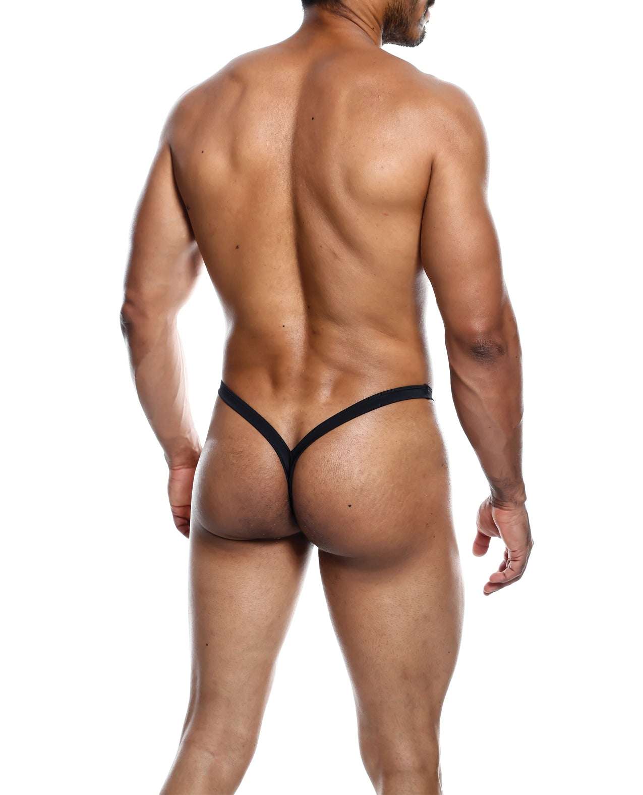 Man wearing black Male Basics Y Buns Thong showcasing sheer, minimal coverage design from the back.