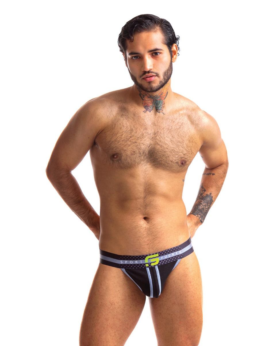 Man wearing Sport Fucker Jersey Jock jockstrap in black and green with branded waistband