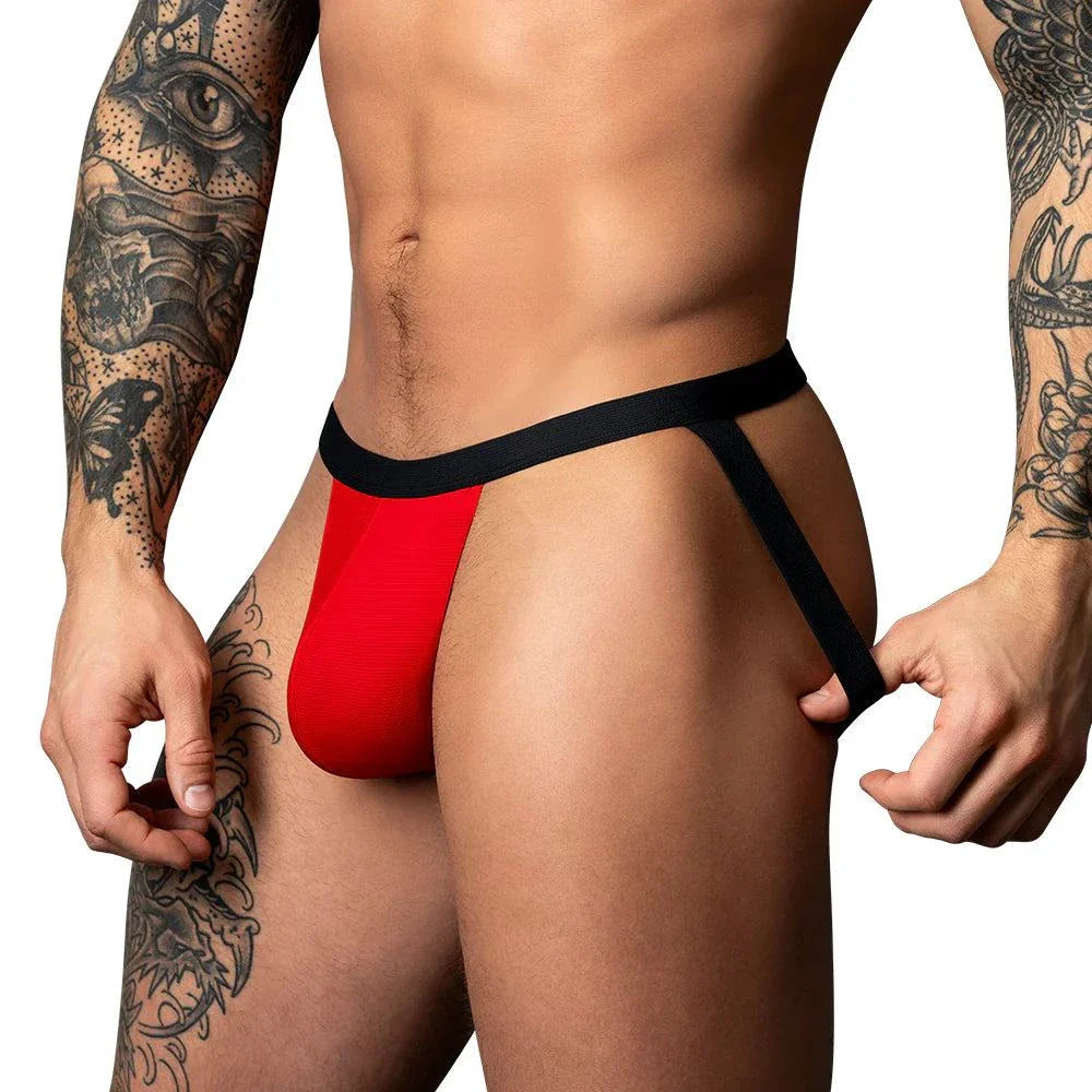 Male model wearing Male Power Hot Mesh Jock in black and red with low-rise waist and contoured pouch.