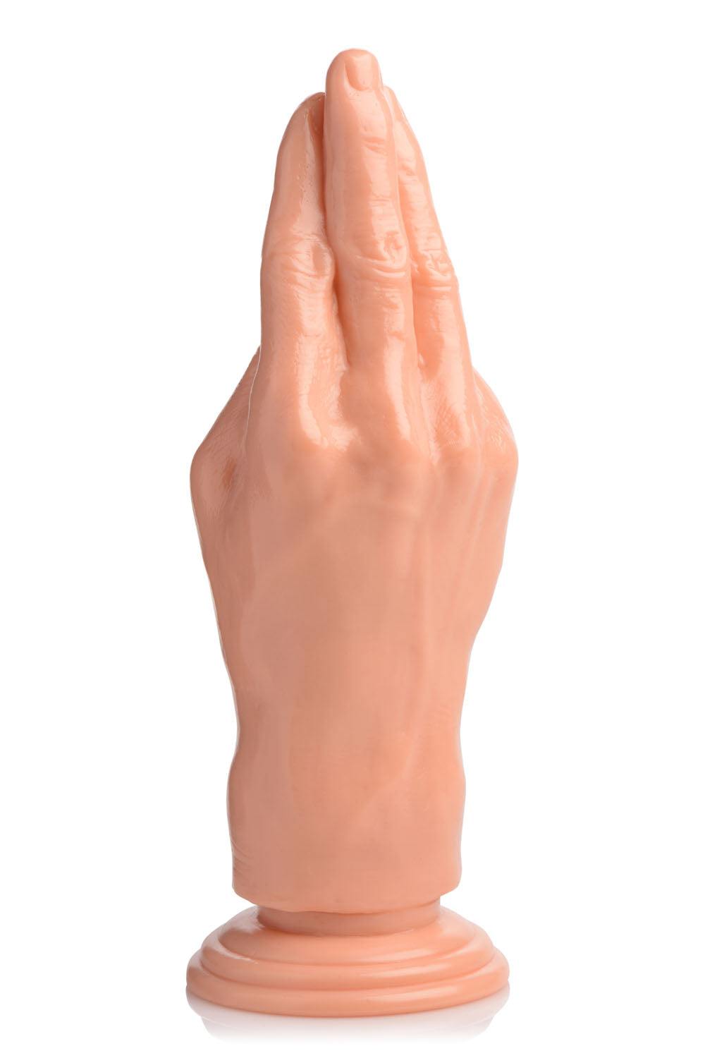 Flesh-colored fisting hand dildo with suction cup base for hands-free use.