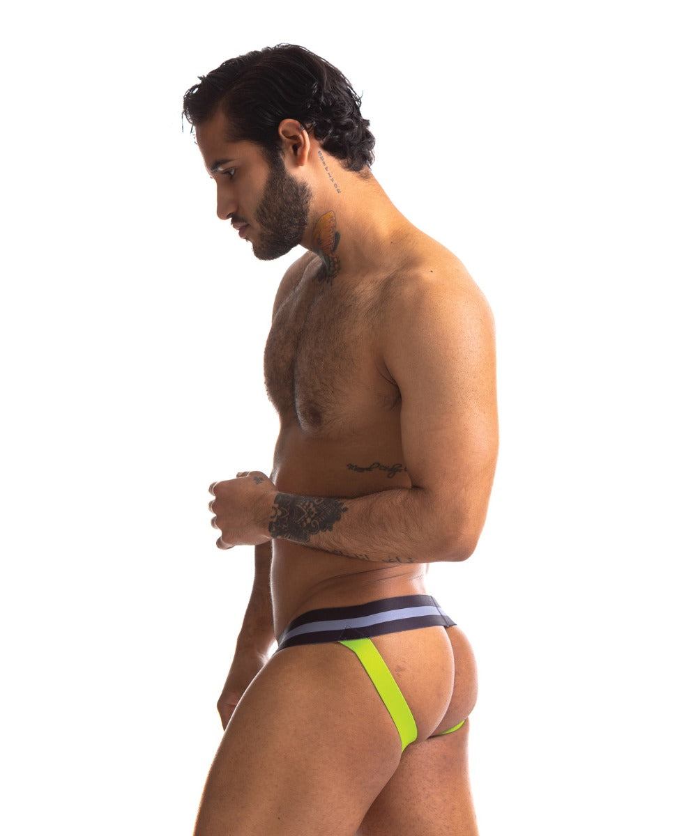 Man wearing black and green Sport Fucker Jersey Jock jockstrap showing side profile