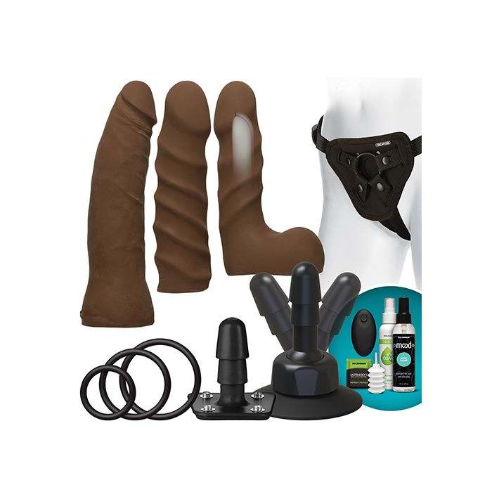 Vac-U-Lock Dual Density Starter Set with adjustable harness, wireless vibrating plug, three chocolate-colored ULTRASKYN attachments, suction cup base, O-rings, and cleaning supplies.