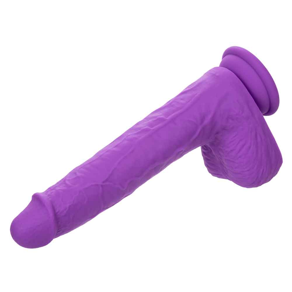 Purple rechargeable gyrating and thrusting silicone stud with suction cup base for hands-free use.