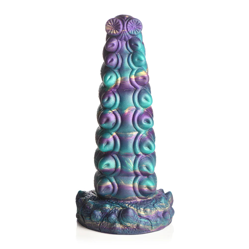 Teal, purple, and gold iridescent silicone dildo with bulging segments, suction cup base, and harness compatibility.