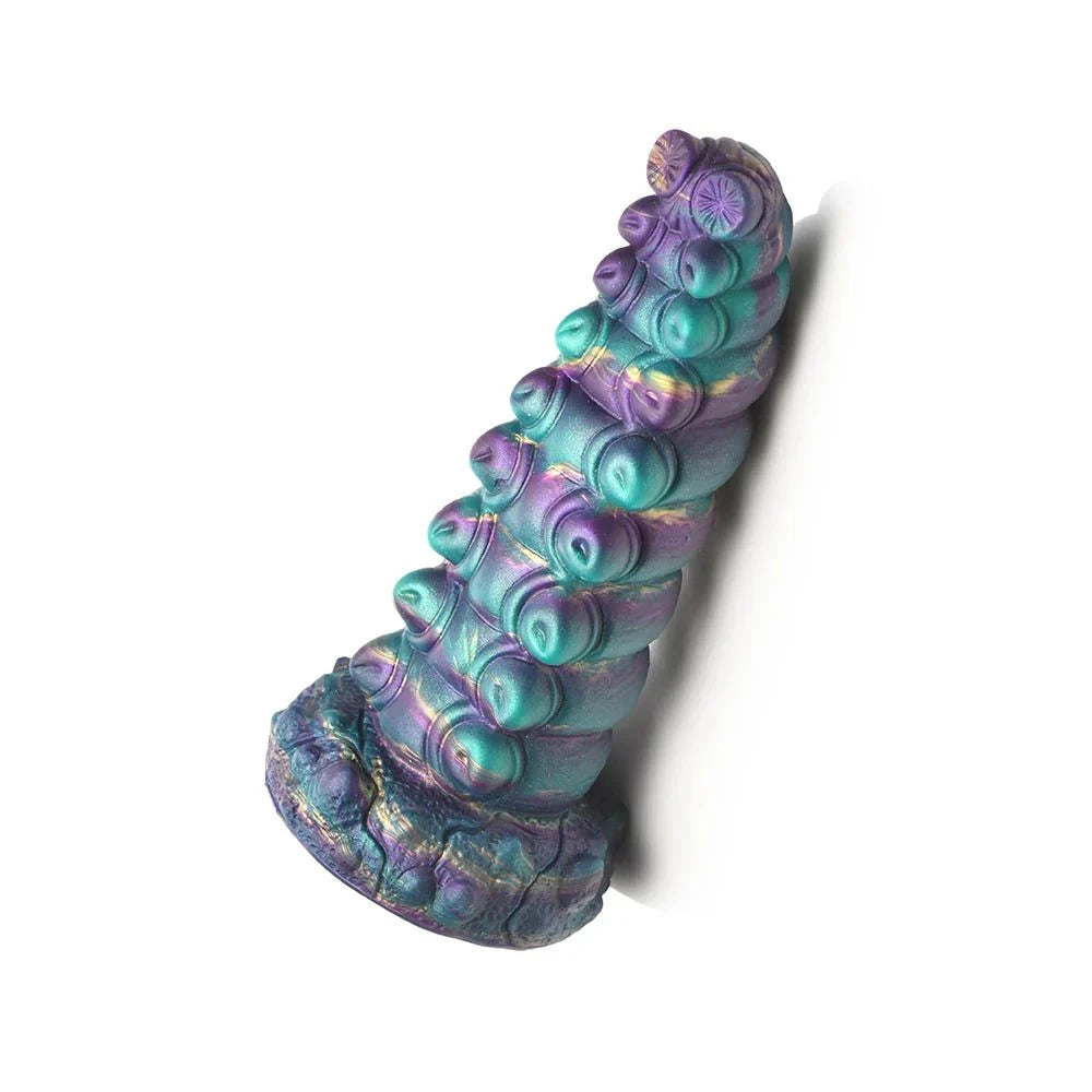 Creature Cocks Chrysalis Silicone Dildo with iridescent teal, purple, gold, and blue coloring and bulging segments.