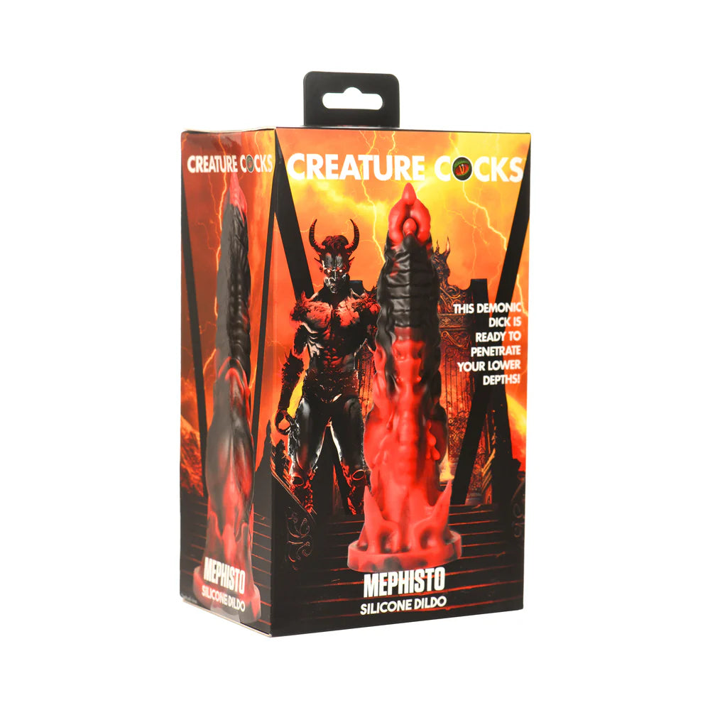 Creature Cocks Mephisto Silicone Dildo in packaging with demonic design and fiery background.