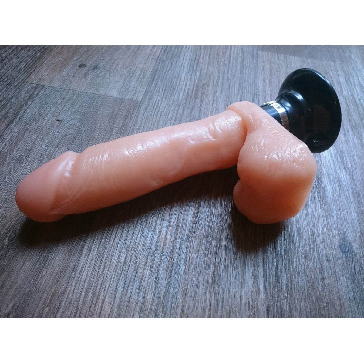 Titan X5 Plus Vibrating Dildo with Suction Cup on wooden surface.