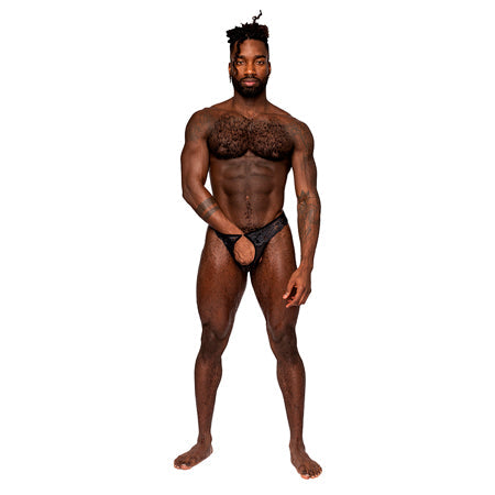 Male model wearing Male Power Sassy Lace Open Ring Thong, showcasing the crotchless pouch and ringed waistband.