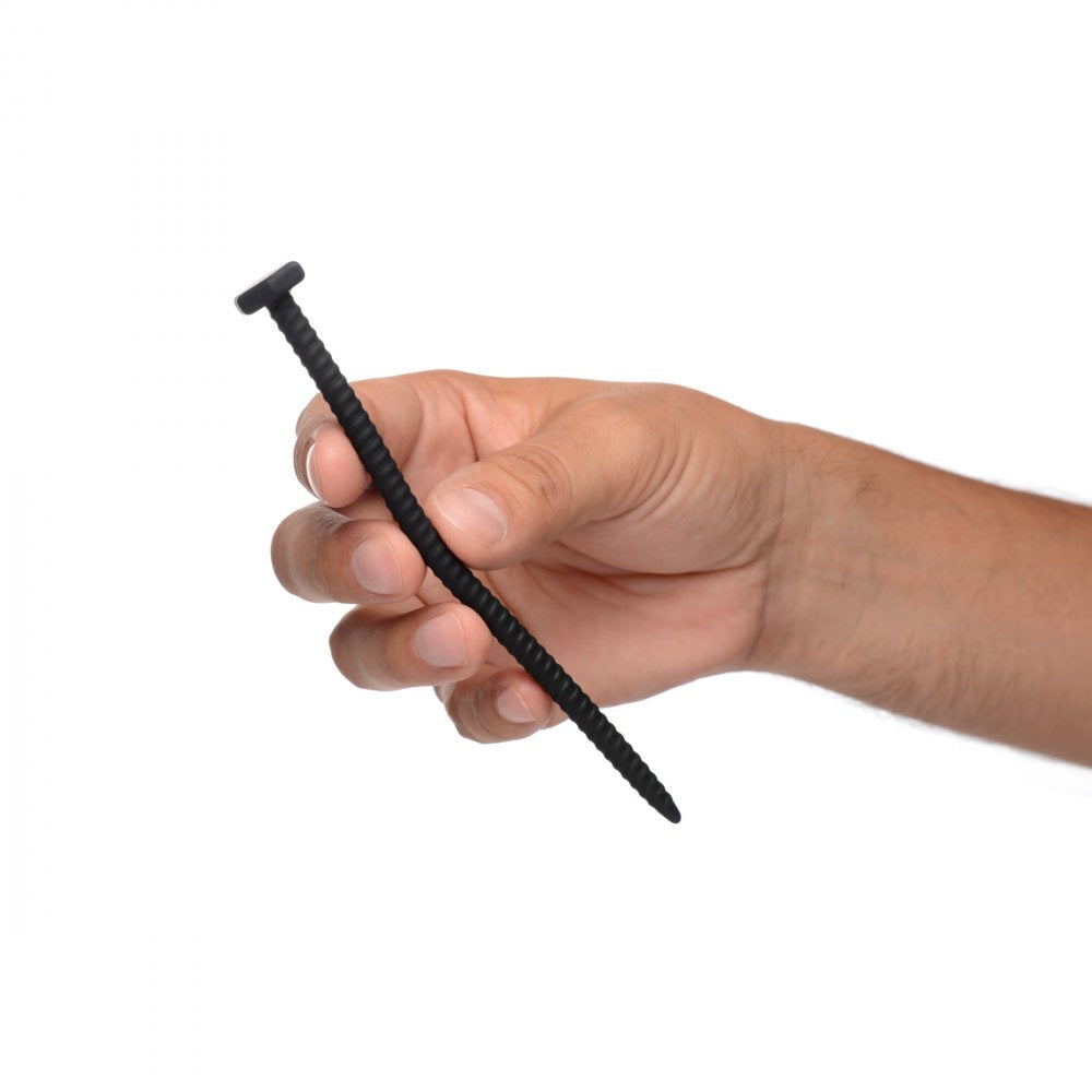 Hand holding a black silicone sound resembling a nail, part of the Hardware - Nail & Screw Silicone Sounds set for pleasure.