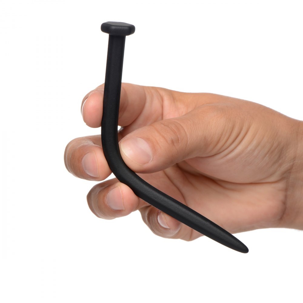 Black silicone sounding rod shaped like a nail, held in a hand.