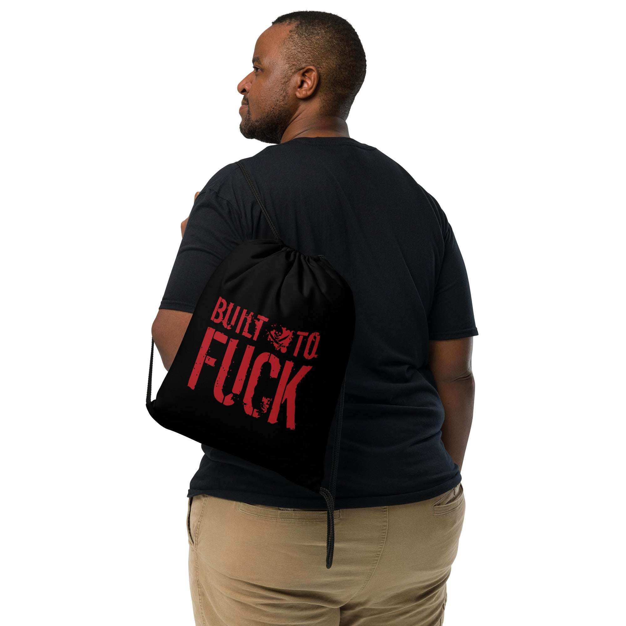 Man wearing a "Built to F*%#" drawstring bag with bold red text, ideal for gym use and casual outings.