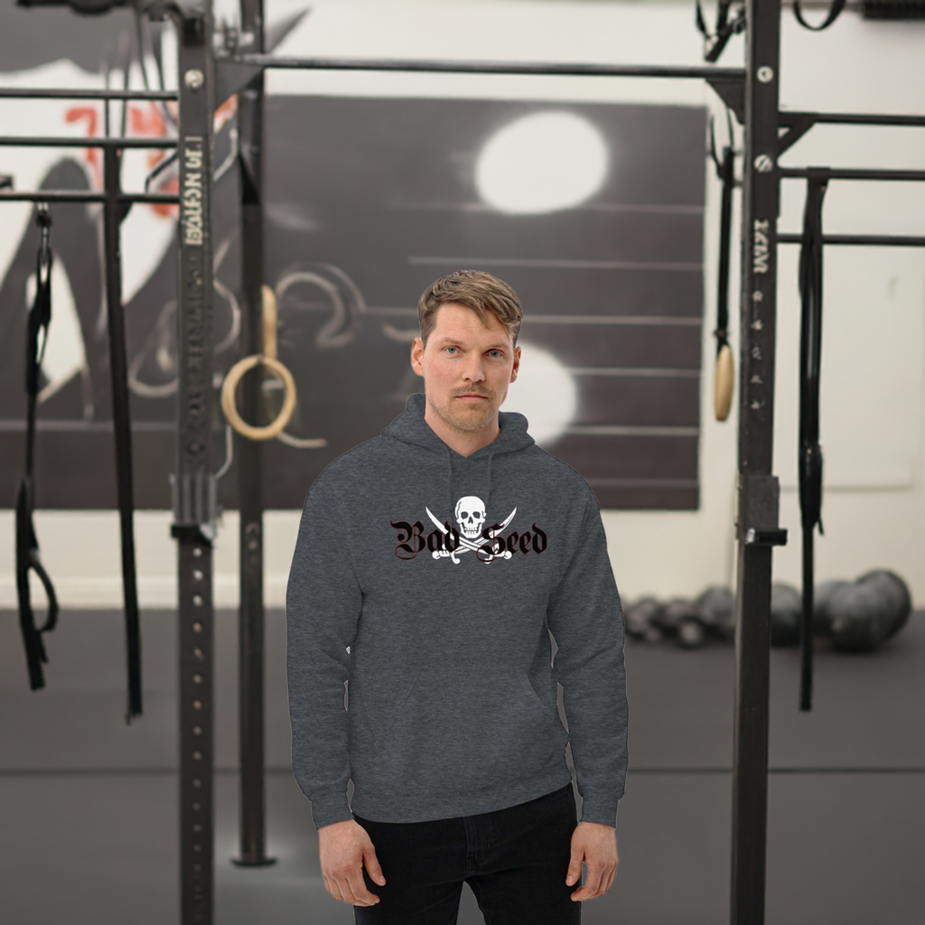 Bad Seed Hoodie featuring bold graphic design from TIM Collection by Treasure Island Media, worn by model in a gym setting.